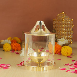 
                  
                    Klassic Medium Akhand Diya with Borosilicate Glass Shade | High-Quality Brass | Oil Lamp | Diya for Pooja, Home Decoration, Gold Lid for Jyoti Lighting in Bedroom, Mandir(5 Inches, Cylindrical)
                  
                