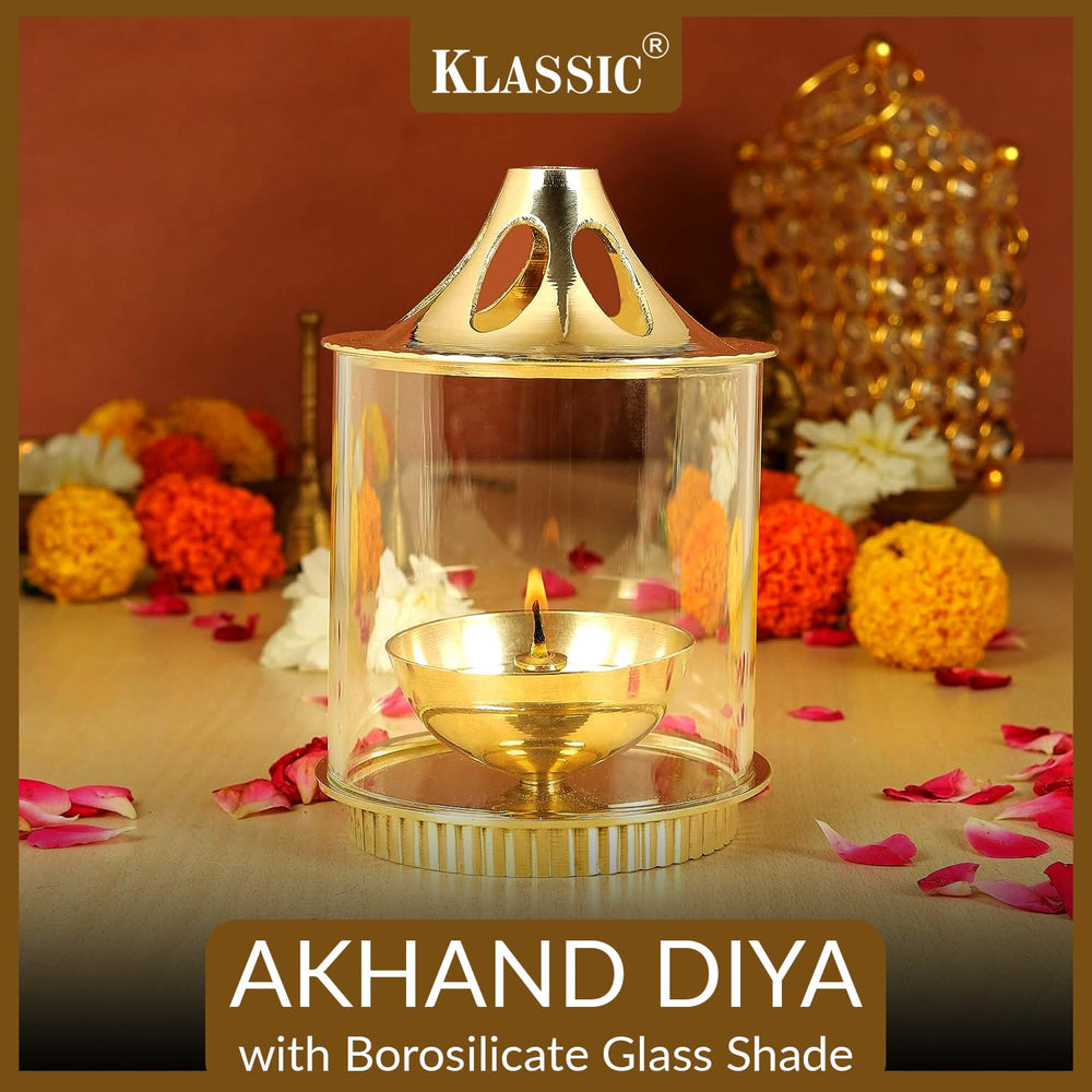 
                  
                    Klassic Medium Akhand Diya with Borosilicate Glass Shade | High-Quality Brass | Oil Lamp | Diya for Pooja, Home Decoration, Gold Lid for Jyoti Lighting in Bedroom, Mandir(5 Inches, Cylindrical)
                  
                