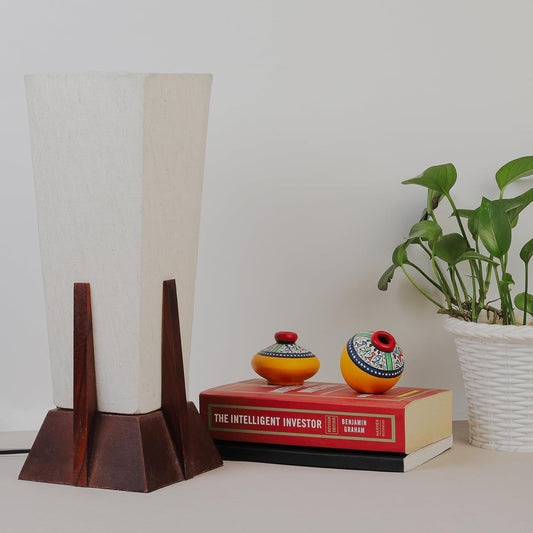 Lexton Wooden Pyramid Table Lamp (14-inch). Designed with a stylish pyramid-shaped wooden base, this lamp blends modern aesthetics with timeless charm, making it a perfect décor piece for bedrooms, living rooms, and office spaces.