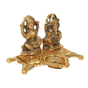 
                  
                    Klassic Ganesha & Laxmi Idol Oil Lamp Diya|Diwali Diya for Puja Diwali Gift Home Temple Articles Decoration Gifts|(Pack of 1,Golden)
                  
                