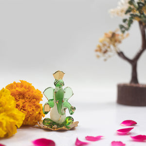 
                  
                    iCraft God Ganesh Sitting on Petal Statue (Murti) Idol Showpiece Handmade of Crystal Glass by for Worship, Decoration, Car Dashboard, Gift (Green)
                  
                